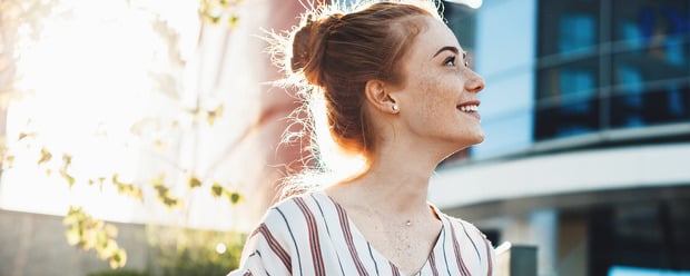 Frau lächelt in die Sonne