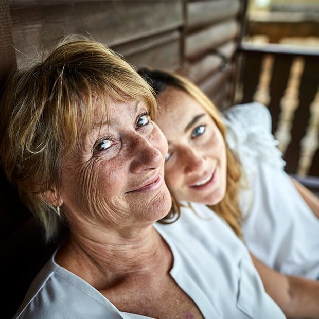 Mutter und Tochter vor Holzhütte